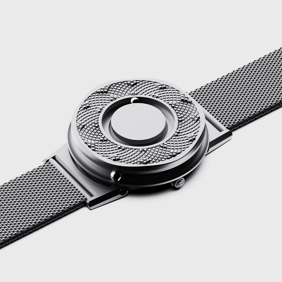 A wristshot of the Eone Rose Gold switch with a black sunflower ring attached. The timepiece is on a male wrist contrasted with a black sleeved top on a black dark background.