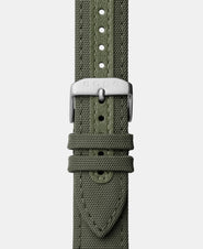 A photo shows the strap lying on a flat surface. One part has a buckle and the other part has a series of holes for an adjustable fit.