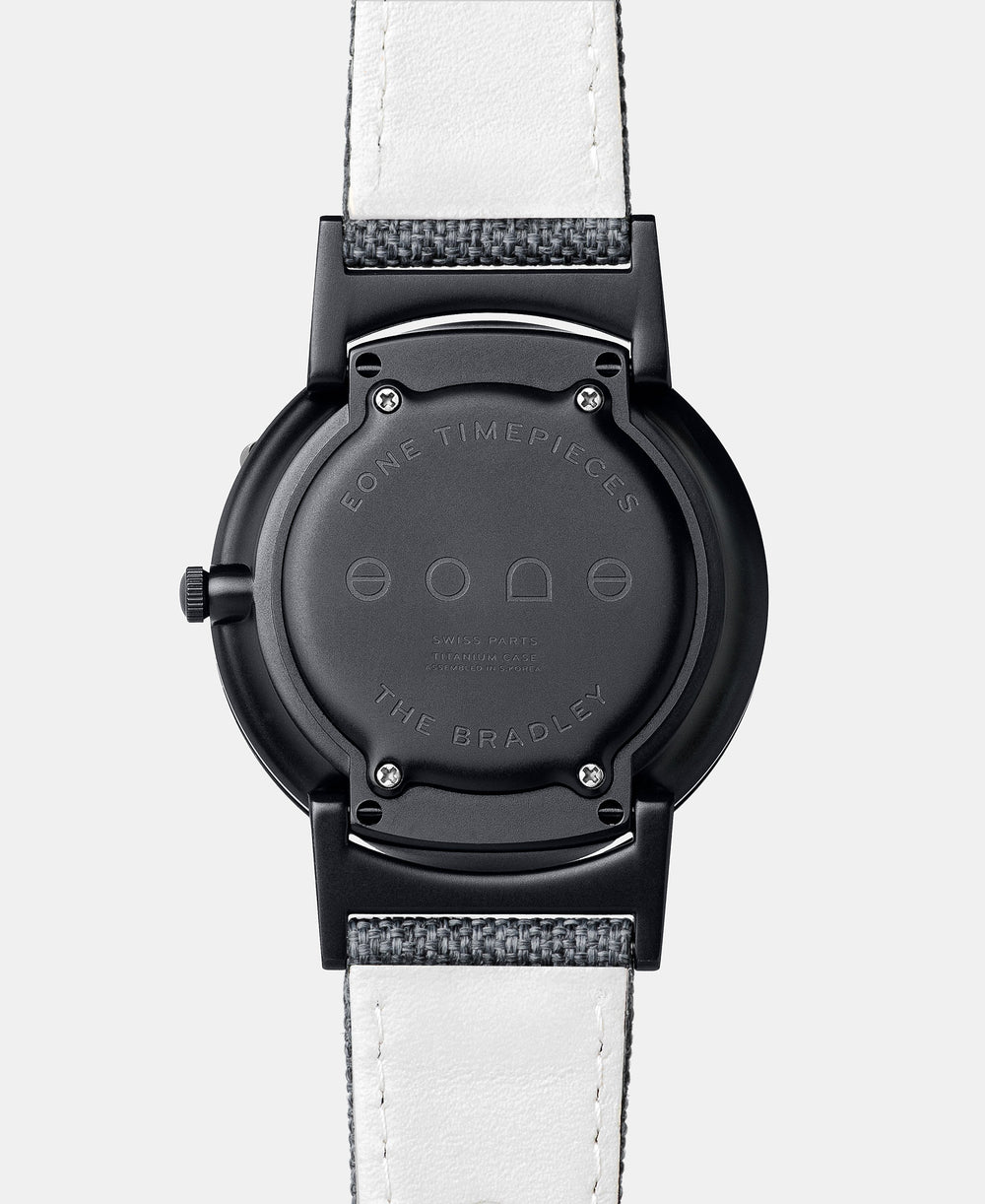 A photo of the back of the watch, showing the back plate engraved with the Eone logo.