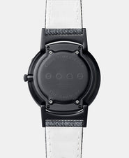 A photo of the back of the watch, showing the back plate engraved with the Eone logo.