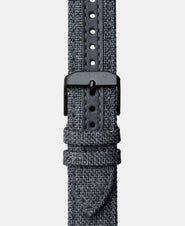 A photo shows the strap lying on a flat surface. One part has a buckle and the other part has a series of holes for an adjustable fit.