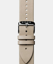 A photo shows the strap lying on a flat surface. One part has a buckle and the other part has a series of holes for an adjustable fit.