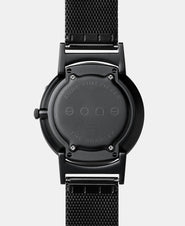 A photo of the back of the watch, showing the back plate engraved with the Eone logo.
