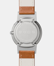 A photo of the back of the watch, showing the back plate engraved with the Eone logo.