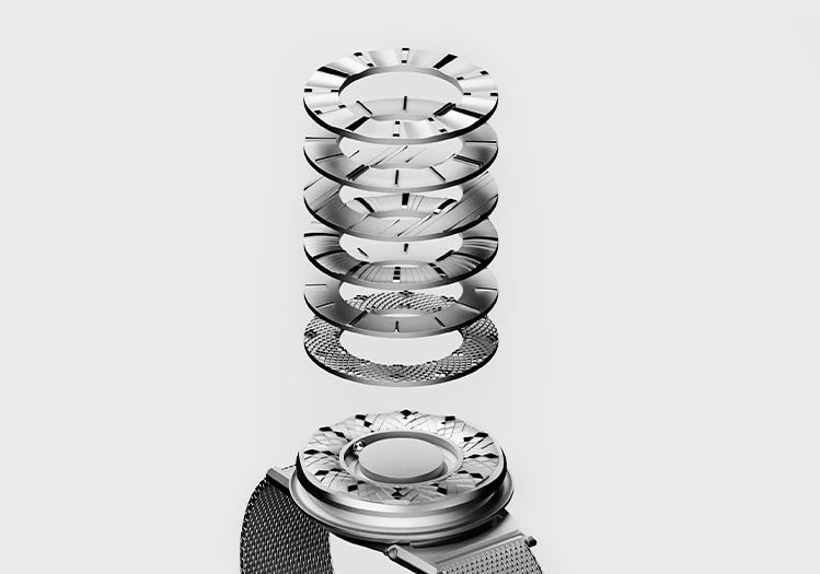 A silver Eone Switch; buckled up, faces upwards against a white space. Above the timepiece, seven rings float equidistance above each other, in a stack. Each ring varies in design and showcases potential concepts that we may bring to life in the future.