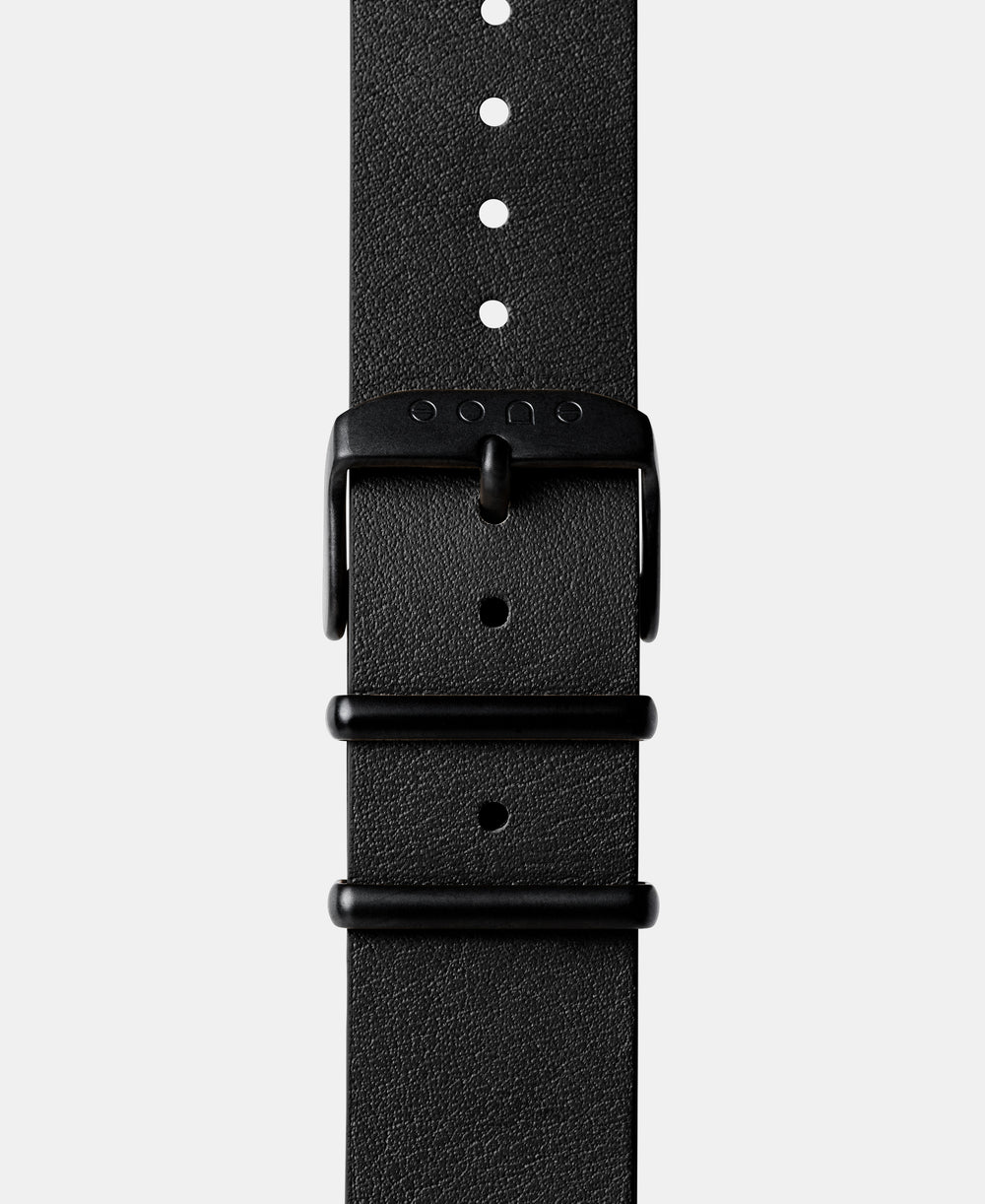 A photo shows the strap lying on a flat surface. One part has a buckle and the other part has a series of holes for an adjustable fit.