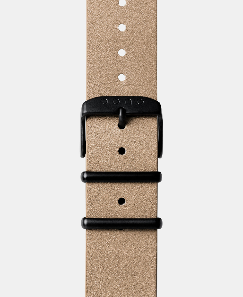 A photo shows the strap lying on a flat surface. One part has a buckle and the other part has a series of holes for an adjustable fit.