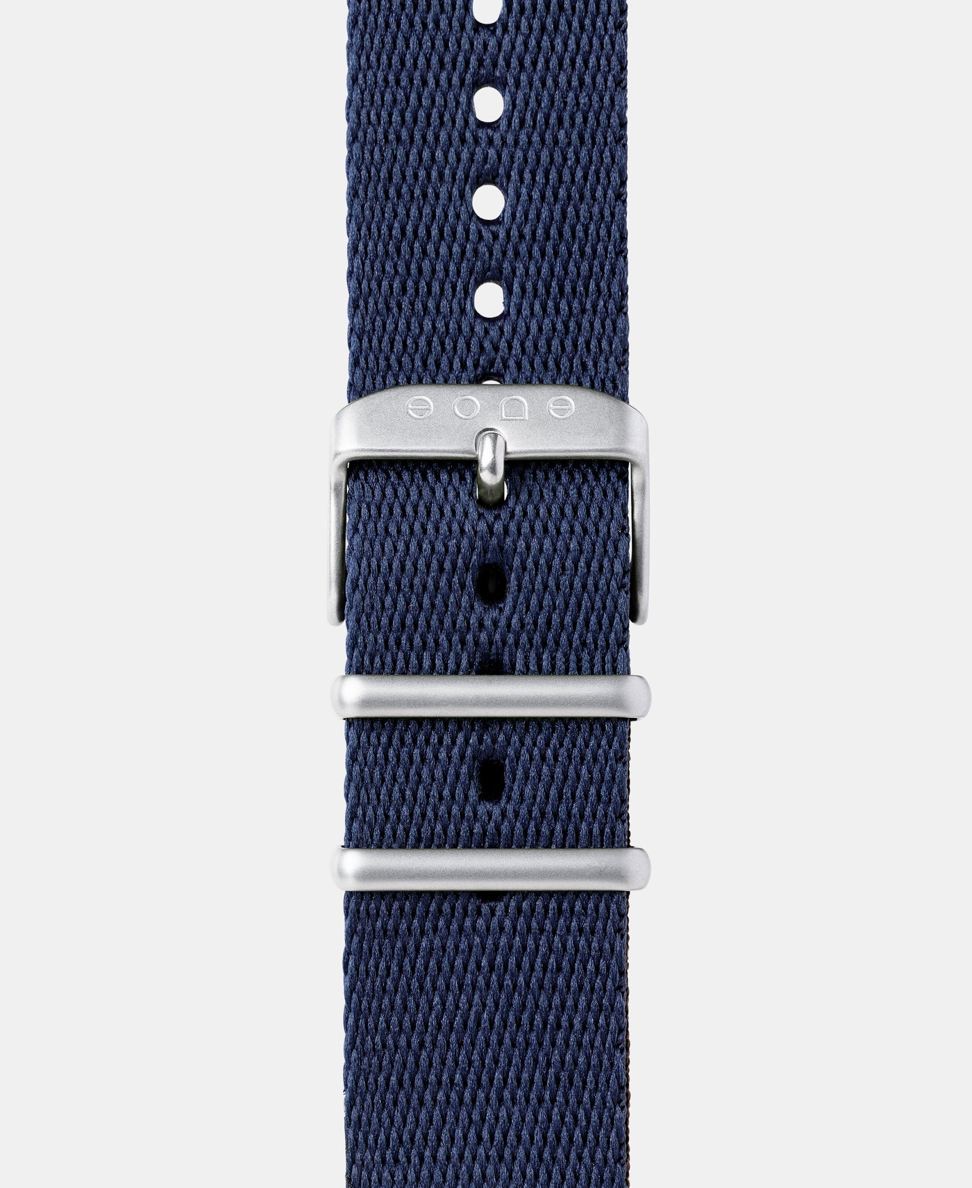 A photo shows the strap lying on a flat surface. One part has a buckle and the other part has a series of holes for an adjustable fit.