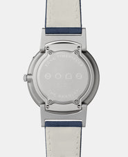 A photo of the back of the watch, showing the back plate engraved with the Eone logo.