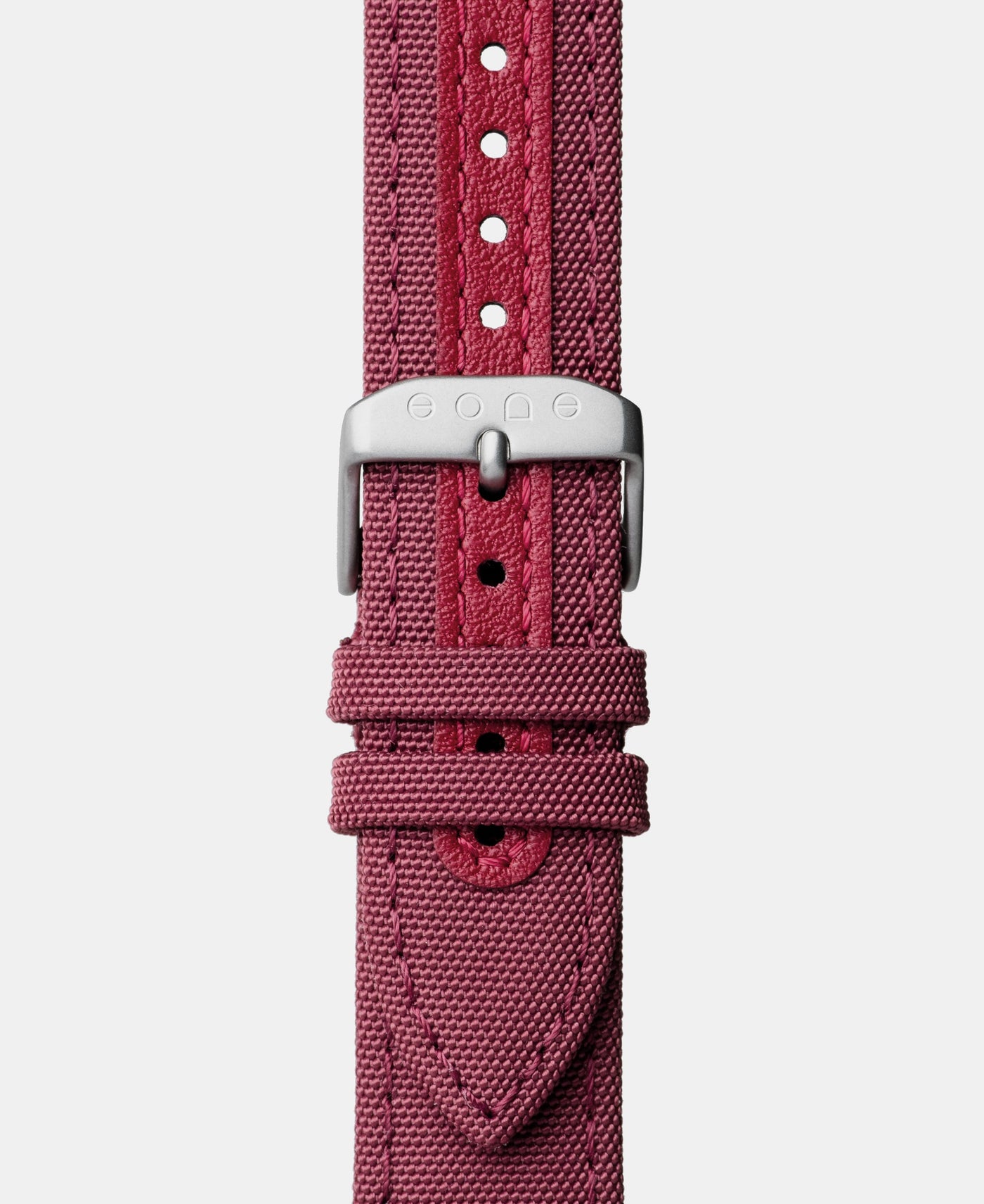 A photo shows the strap lying on a flat surface. One part has a buckle and the other part has a series of holes for an adjustable fit.
