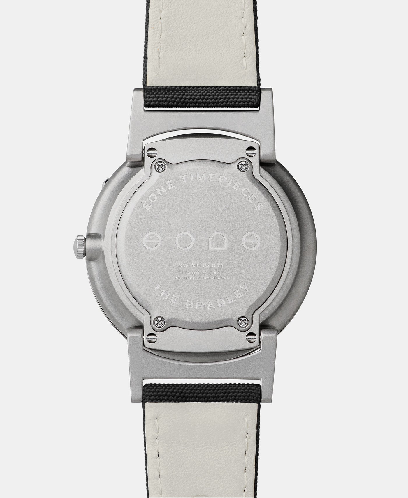 A photo of the back of the watch, showing the back plate engraved with the Eone logo.