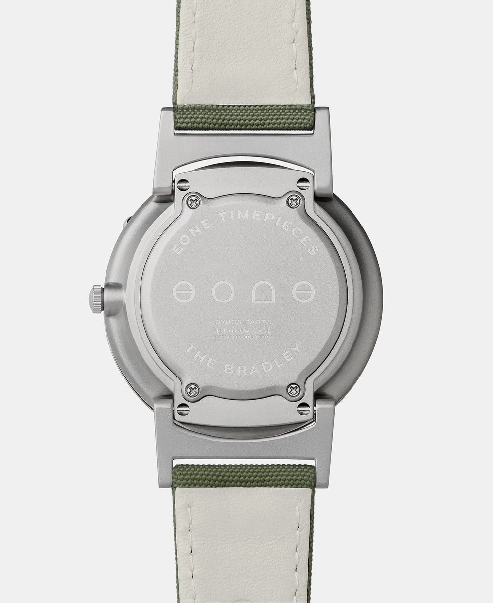 A photo of the back of the watch, showing the back plate engraved with the Eone logo.