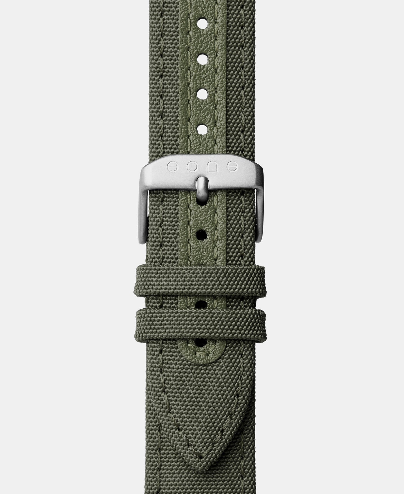A photo shows the strap lying on a flat surface. One part has a buckle and the other part has a series of holes for an adjustable fit.