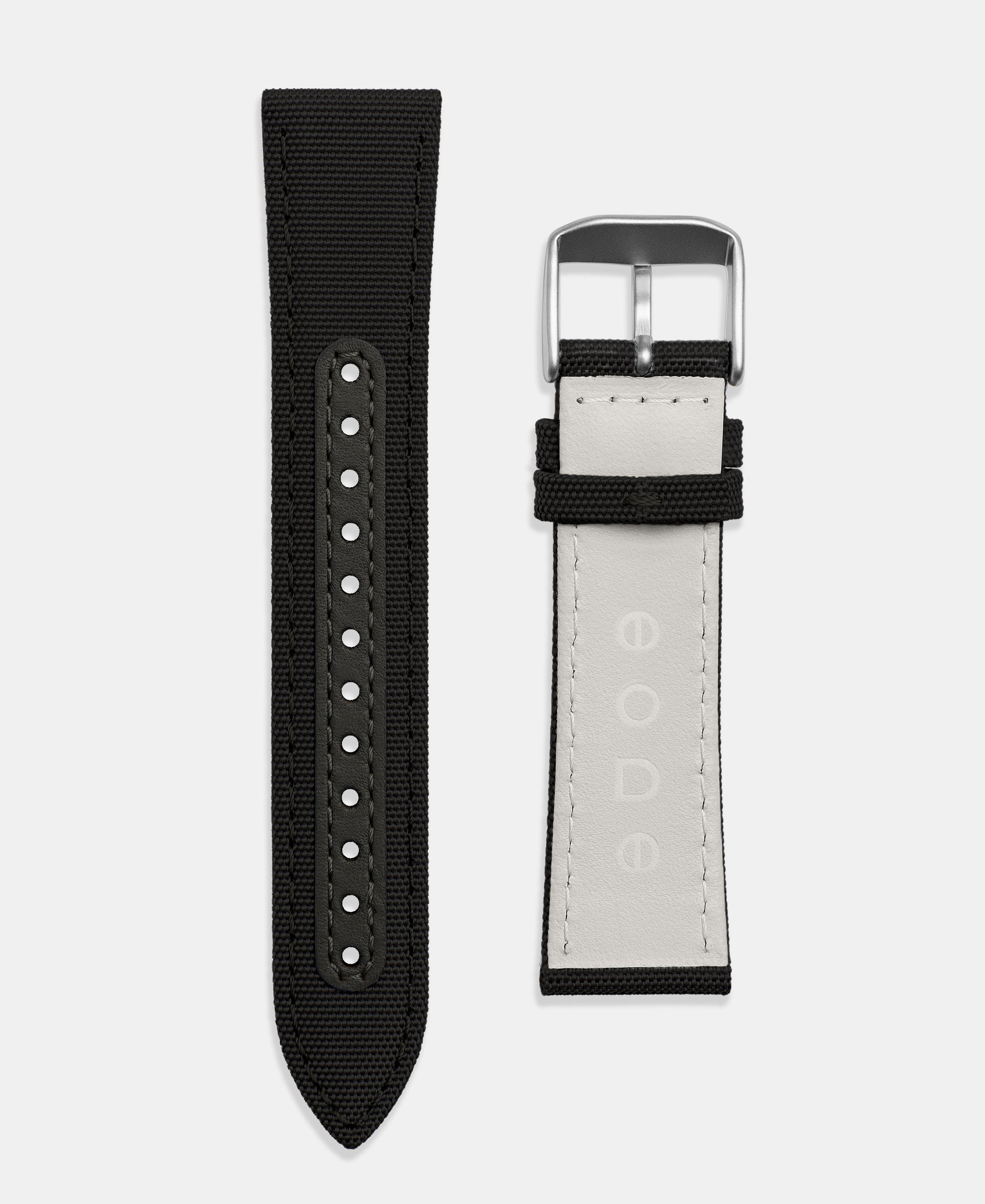 A photo shows the strap lying on a flat surface. One part has a buckle and the other part has a series of holes for an adjustable fit.