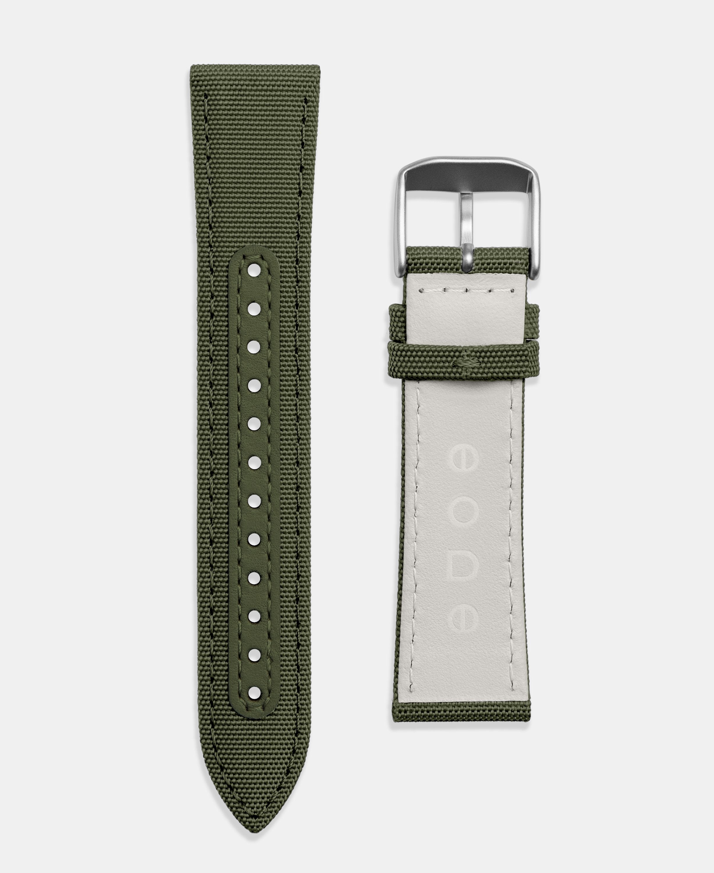 A photo shows the strap lying on a flat surface. One part has a buckle and the other part has a series of holes for an adjustable fit.
