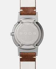A photo of the back of the watch, showing the back plate engraved with the Eone logo.