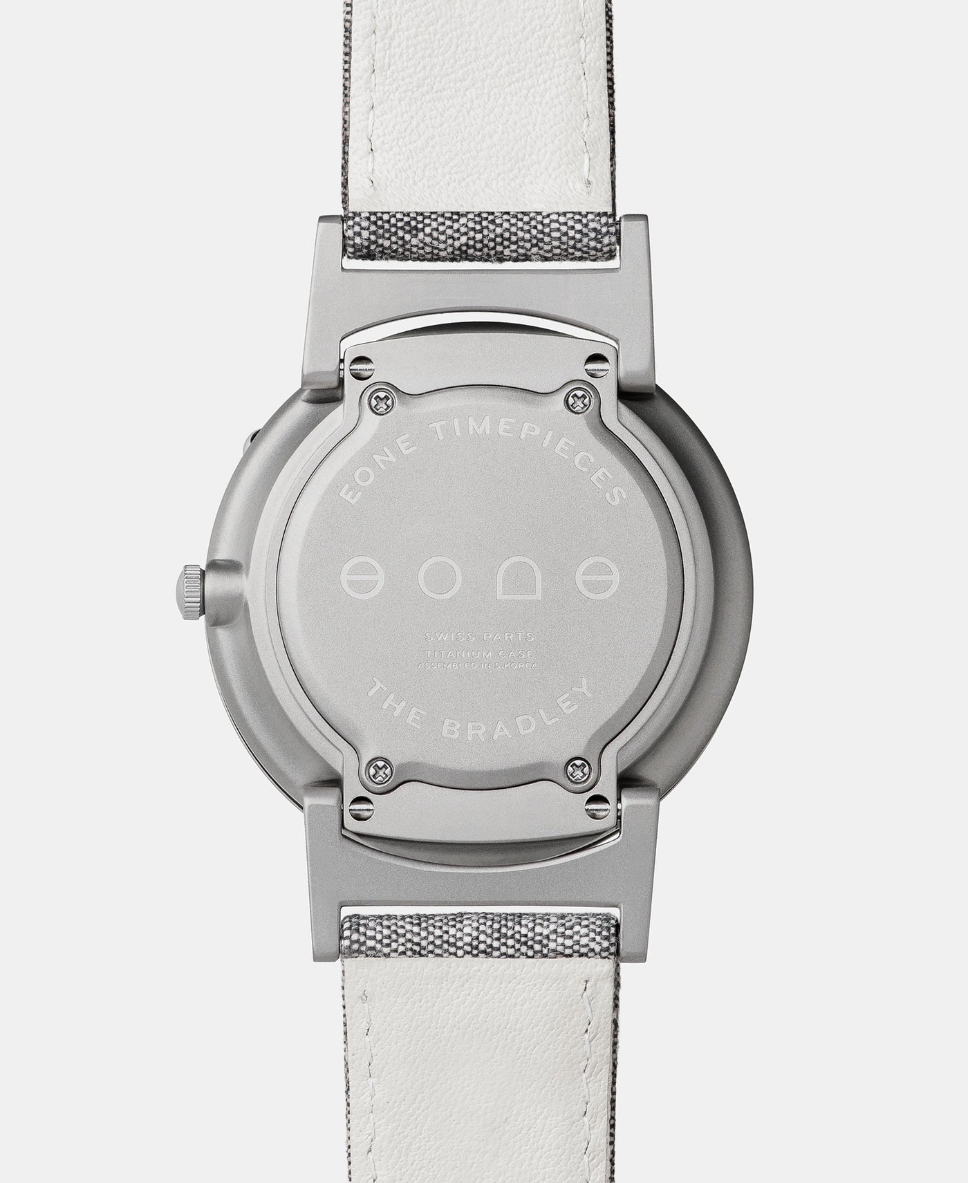A photo of the back of the watch, showing the back plate engraved with the Eone logo.
