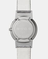 A photo of the back of the watch, showing the back plate engraved with the Eone logo.