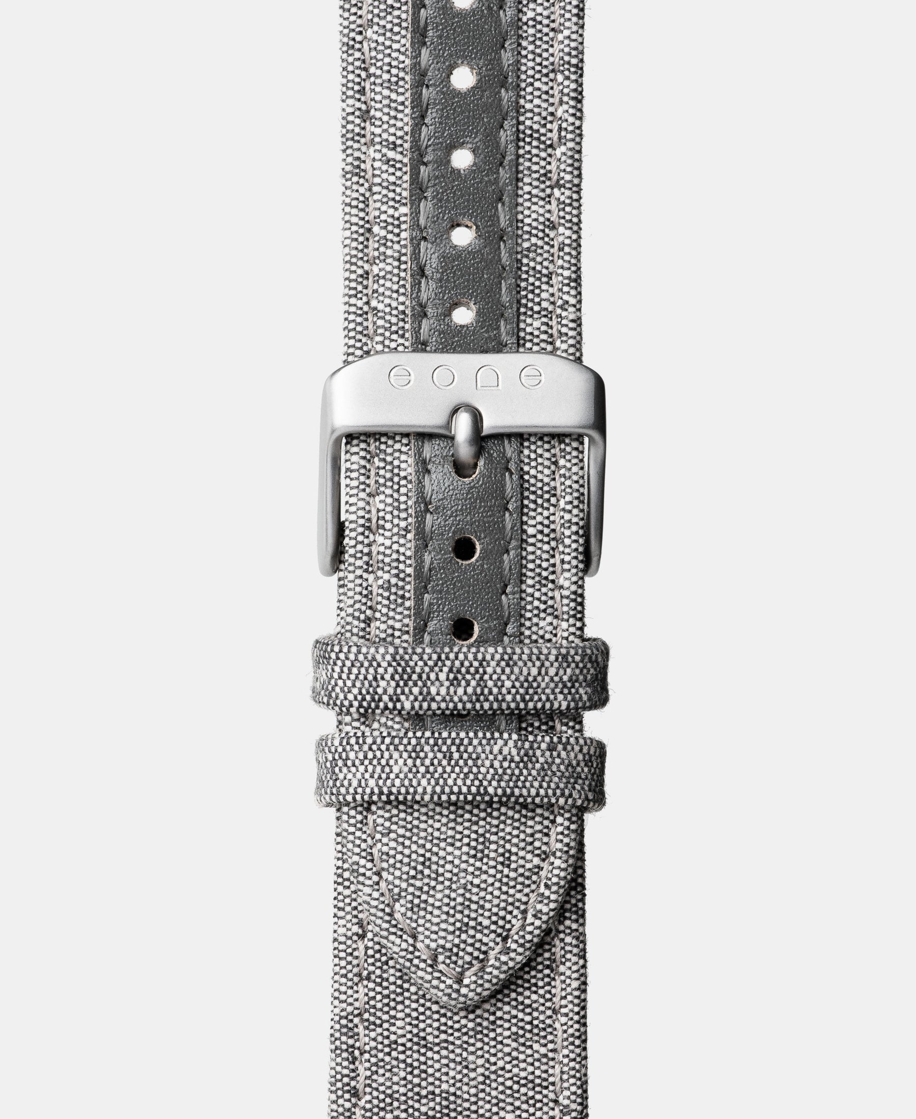 Load image into Gallery viewer, A photo shows the strap lying on a flat surface. One part has a buckle and the other part has a series of holes for an adjustable fit.