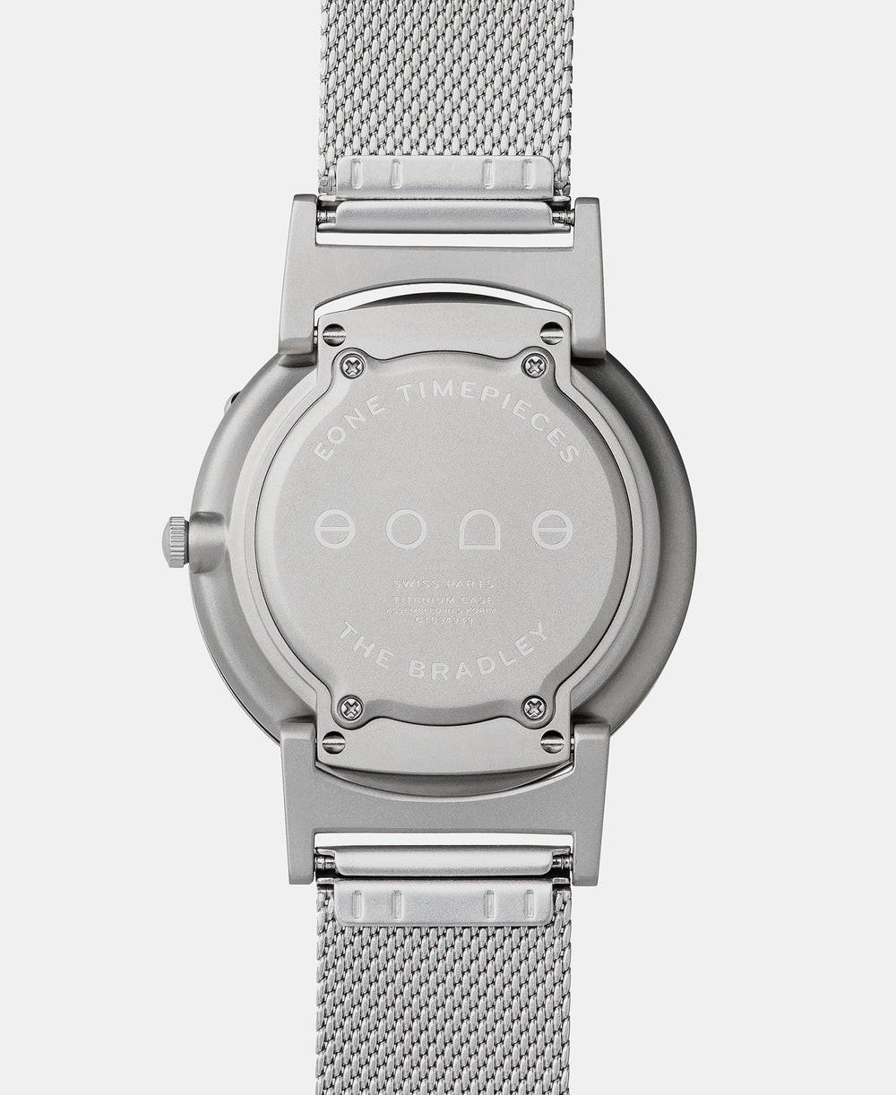 A photo of the back of the watch, showing the back plate engraved with the Eone logo.