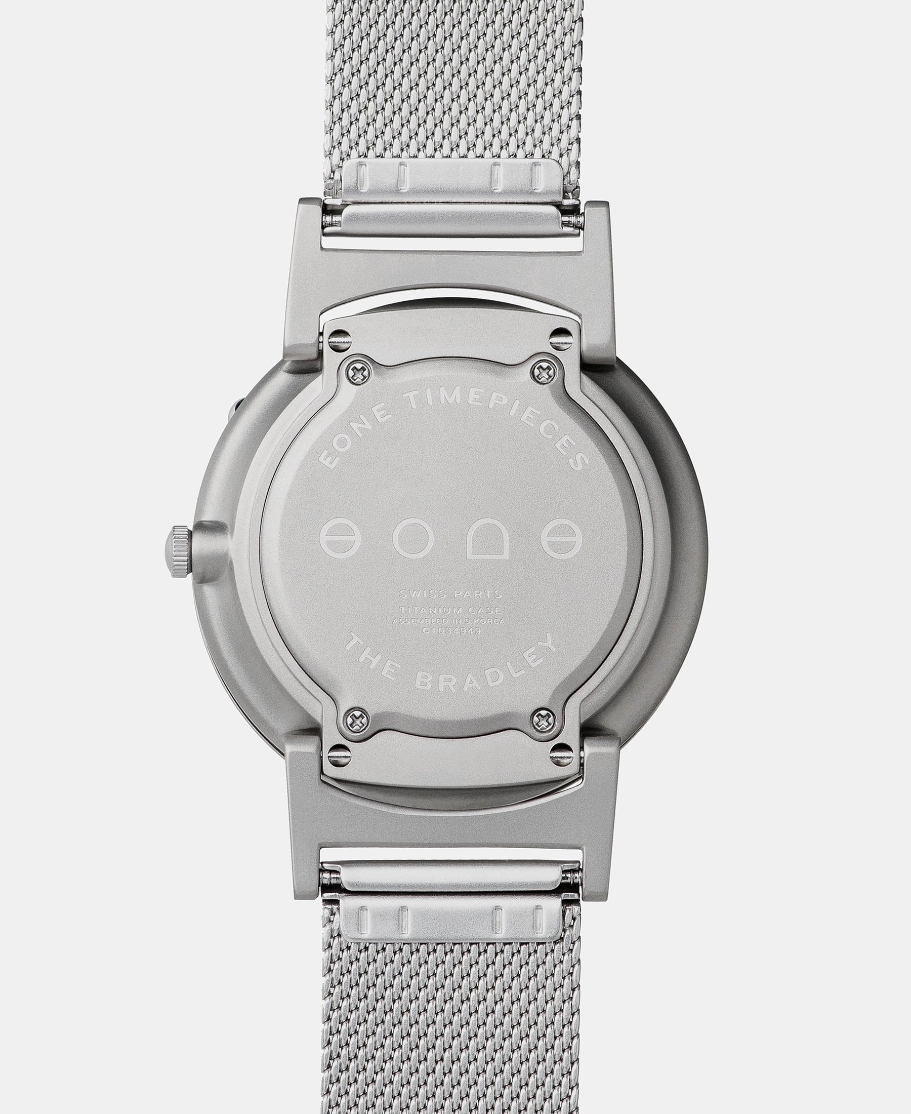 Load image into Gallery viewer, A photo of the back of the watch, showing the back plate engraved with the Eone logo.