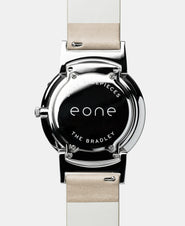 A photo of the back of the watch, showing the back plate engraved with the Eone logo.
