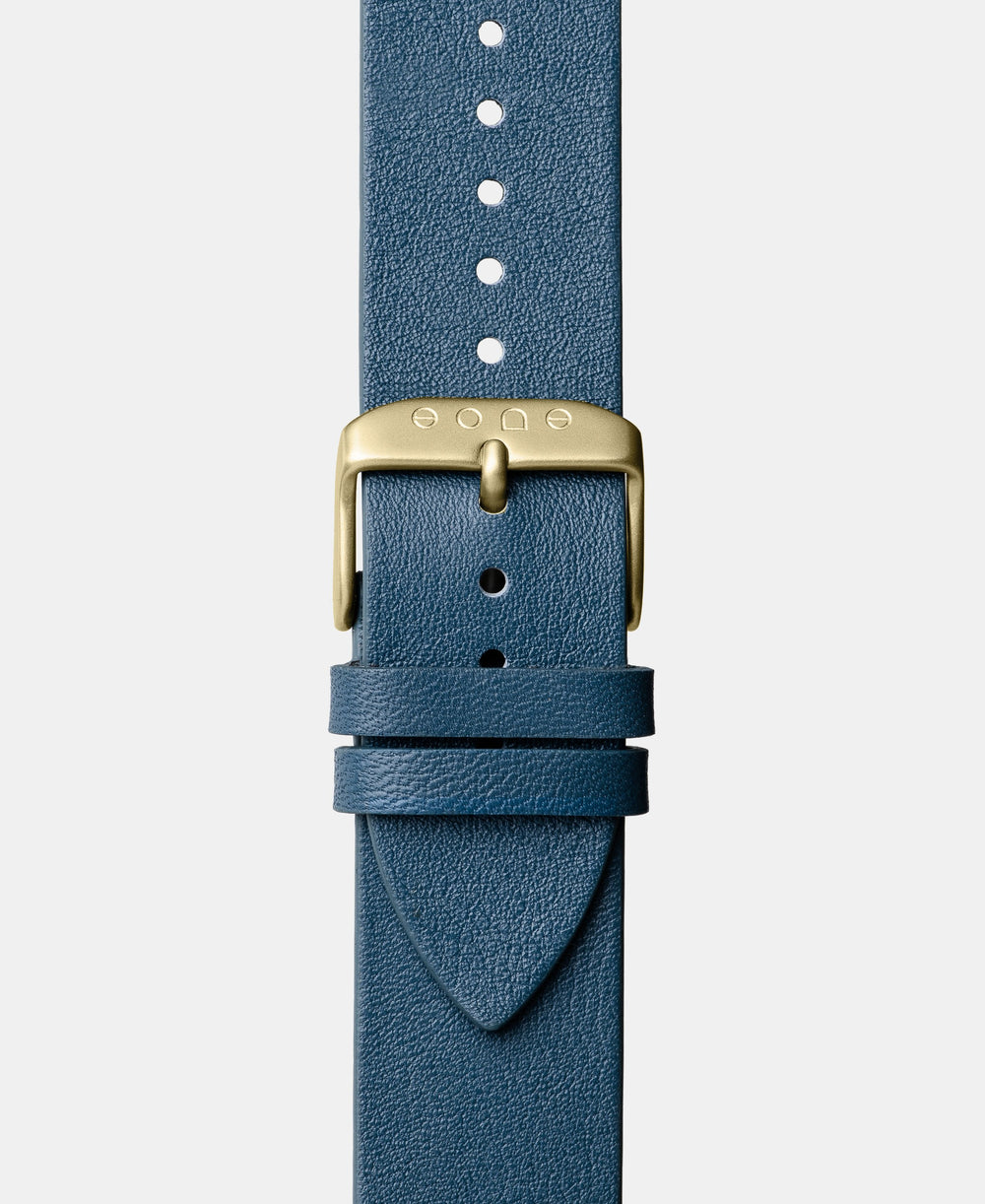 A photo shows the strap lying on a flat surface. One part has a buckle and the other part has a series of holes for an adjustable fit.