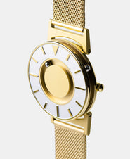 A photo of the watch from a side angle. The recessed track around the outside of the watch face is shown with the hour ball bearing in the track. The raised markers are noticeable from this perspective.