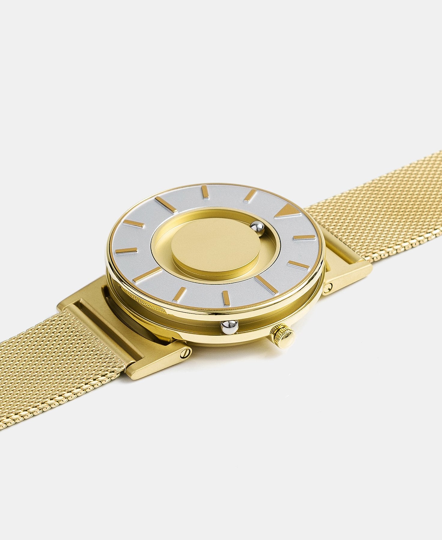 Load image into Gallery viewer, A photo of the watch lying flat on a surface. The recessed track around the outside of the watch face is shown with the hour ball bearing in the track. The raised markers are noticeable from this perspective.