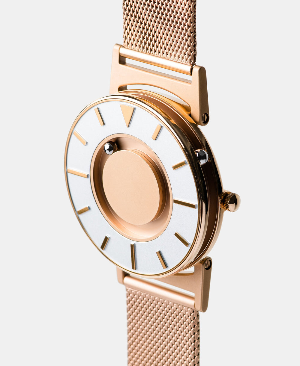 A photo of the watch from a side angle. The recessed track around the outside of the watch face is shown with the hour ball bearing in the track. The raised markers are noticeable from this perspective.