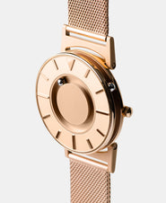 A photo of the watch from a side angle. The recessed track around the outside of the watch face is shown with the hour ball bearing in the track. The raised markers are noticeable from this perspective.