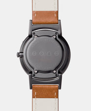 A photo of the back of the watch, showing the back plate engraved with the Eone logo.